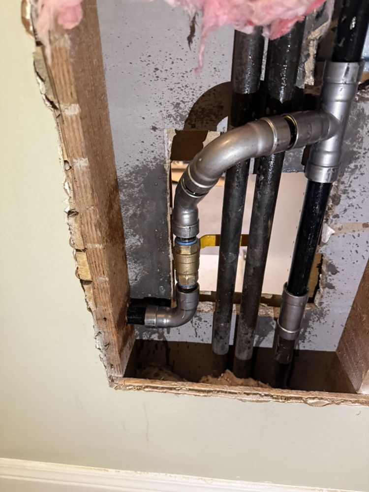 PEX plumbing manifold neatly installed inside an apartment wall cavity