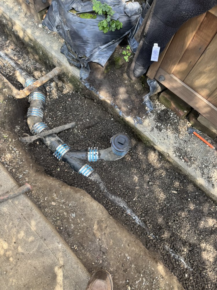 Excavated trench showing new sewer line couplings