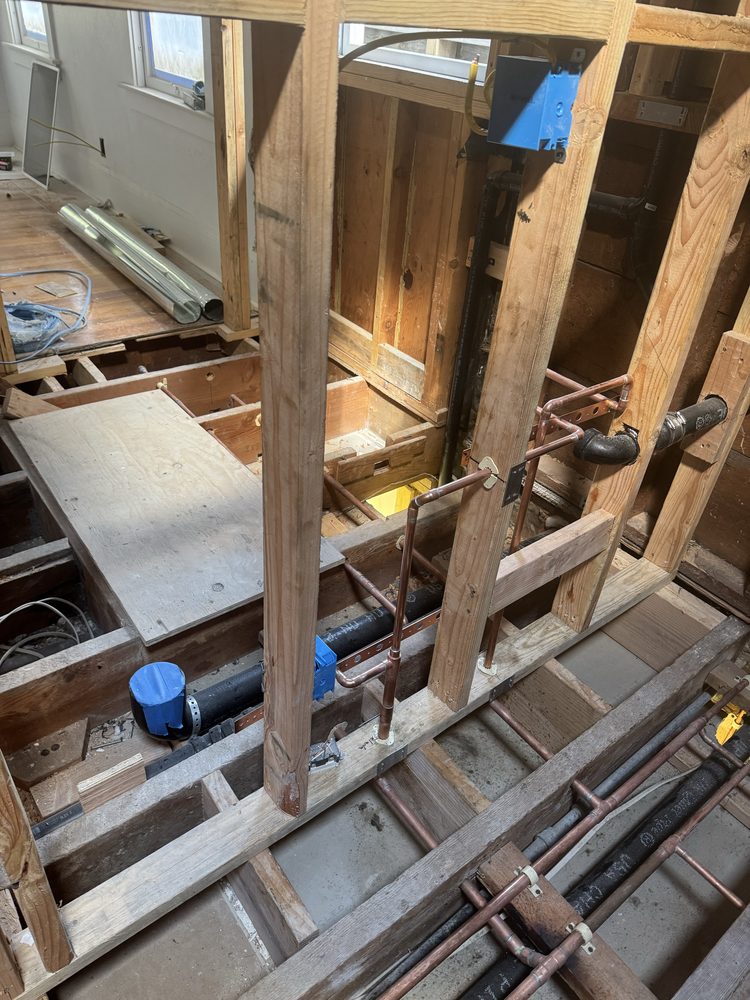Open wall framing during a whole-home copper repipe